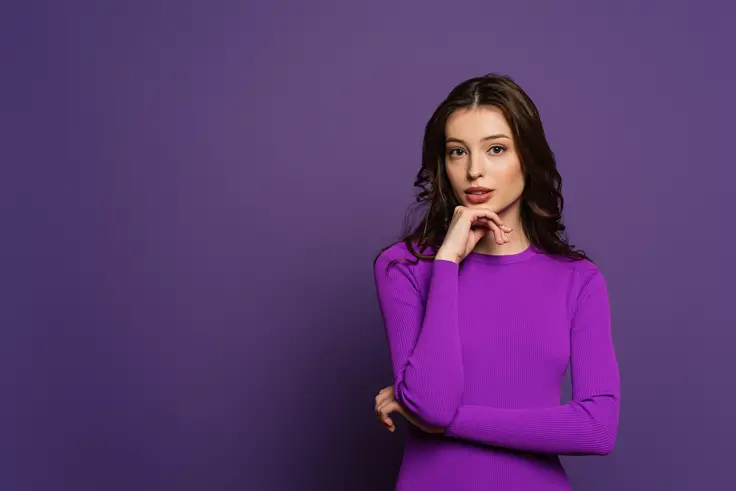 female posing wearing purple dress with purple background to cheer valentines day color code